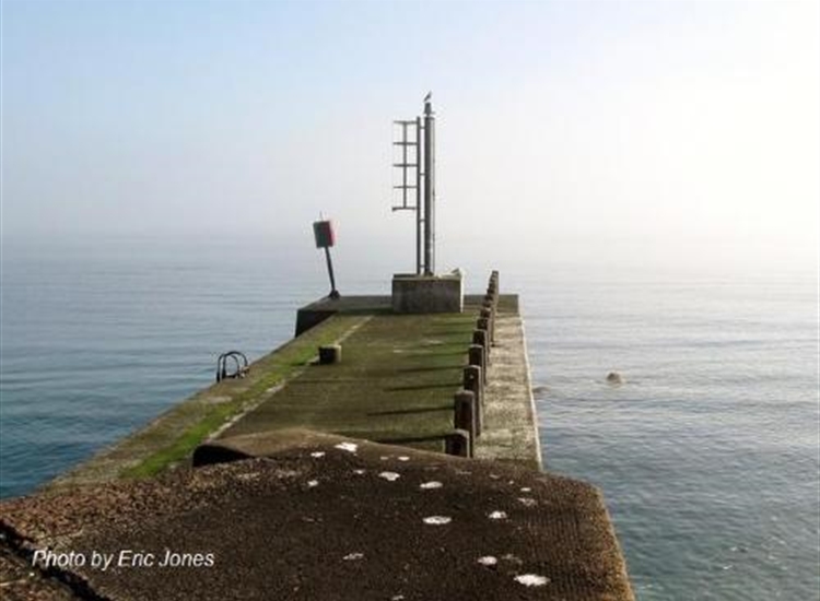 Annalong pier wall.Note the shoal rocks