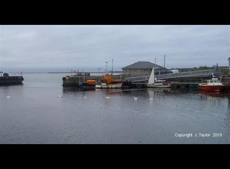 New pontoon (55Â°45.876'N, 2Â° 0.466'W). It shows the dock entrance and a view beyond to the river mouth.