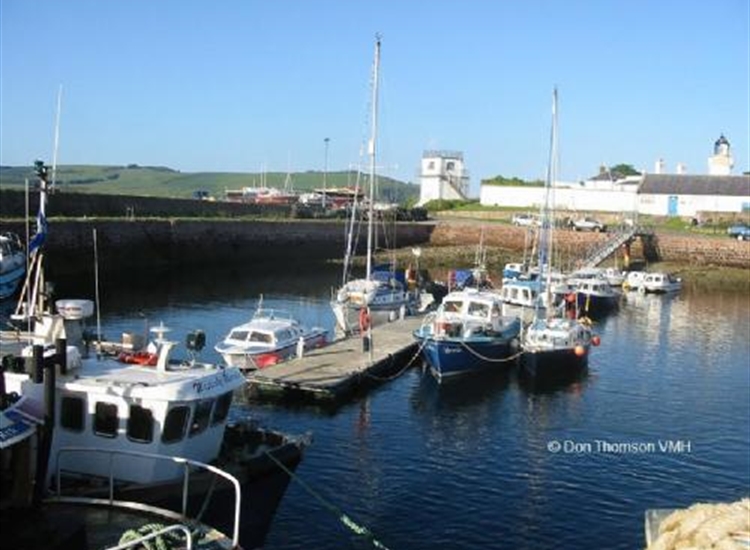 Cromarty pontoon. Boat Club tower centre & light house centre right