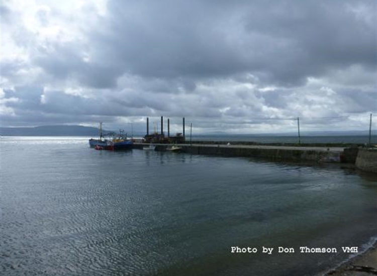 Carrickarory Pier with a dredging boat alongside