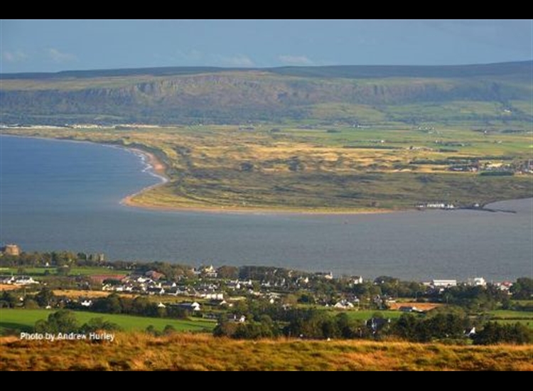 Magilligan point from behind Greencastle with the ruined castle and Martello Tower on left
