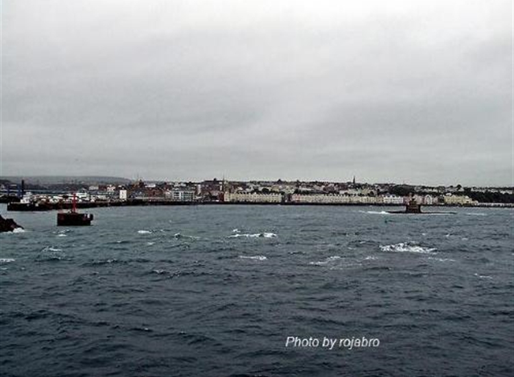 Douglas from the E by N. Harbour entrance opening on left. Refuge Tower on right