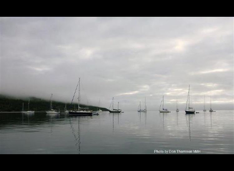 Rum B. Yachts at anchor in Loch Scresort, fog beginning to lift